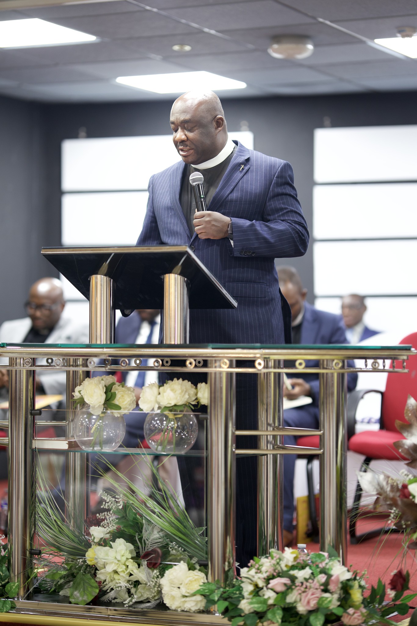 Community members in prayer during a fellowship gathering